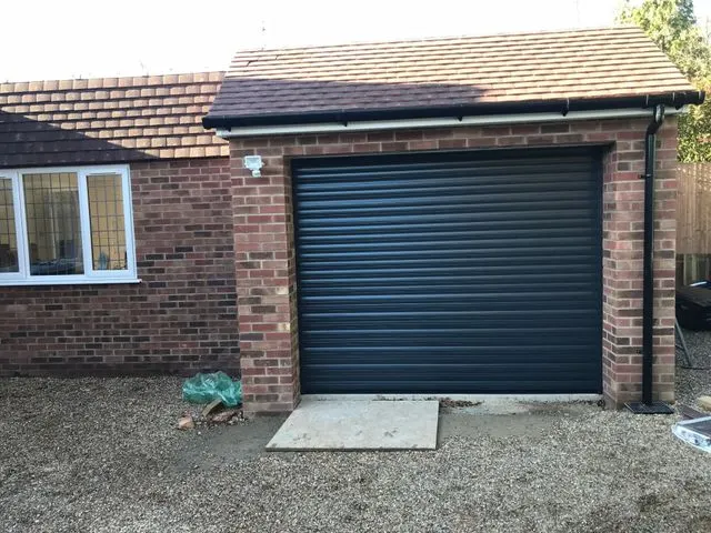 Blue garage door installation on a terraced property in West London