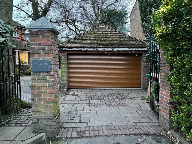 Oak effect roller garage door fitted at Stamford House by Doors 4 Garages Ltd
