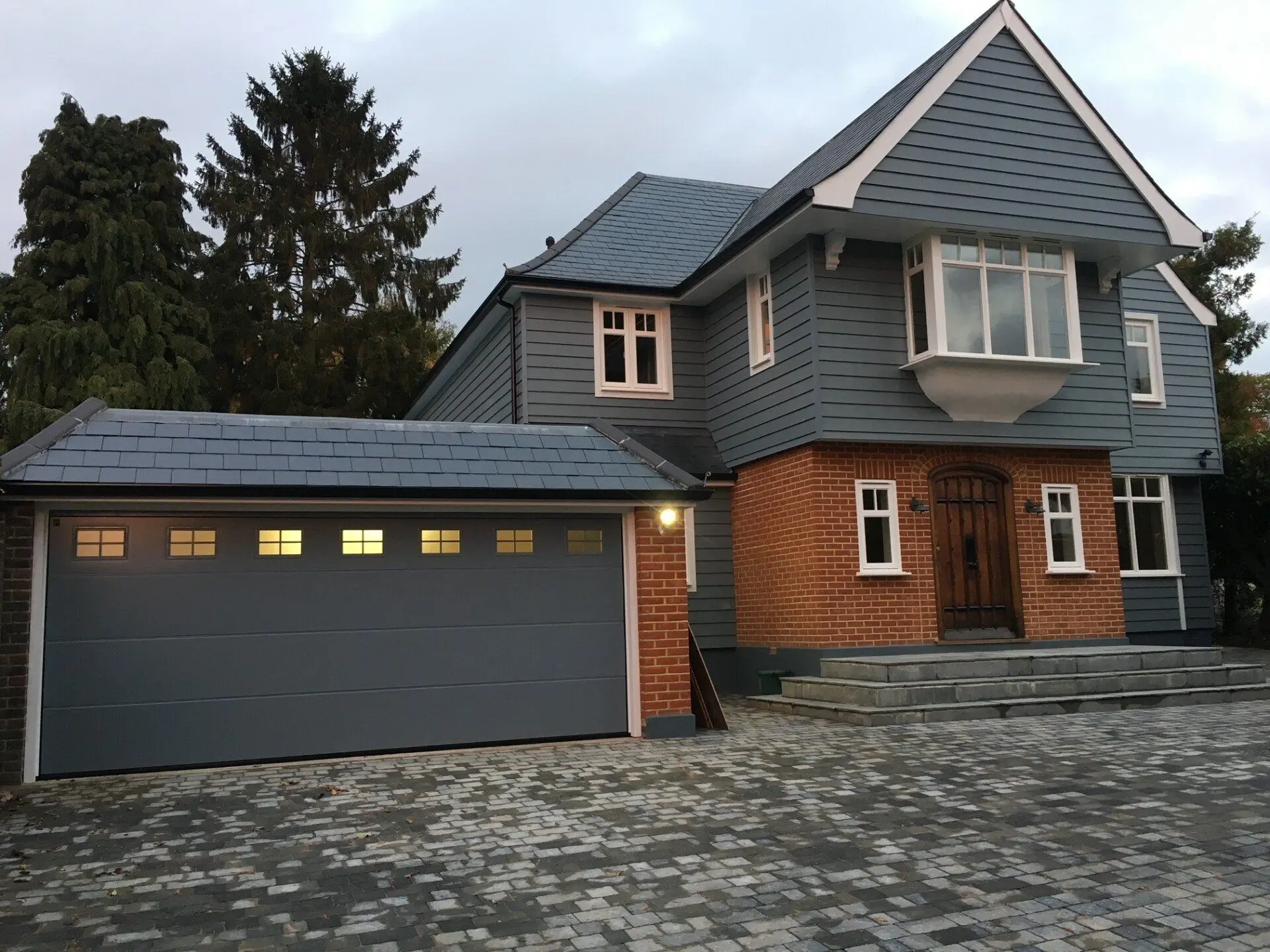 Grey sectional double garage door fitted to a new build home by Doors 4 Garages Ltd in Twickenham