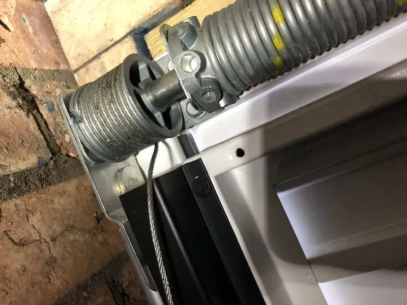 Garage door spring, cable drum and roller mechanism replaced by Doors 4 Garages Ltd Twickenham